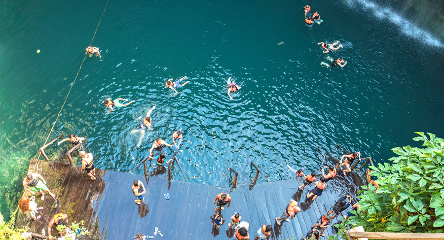 View of tourists having a swim in Sacred Cenote