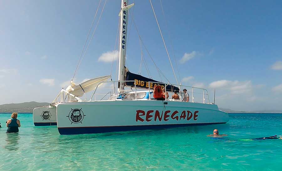 View of people on a sailboat and at the water of Buck Island Reef National Monument