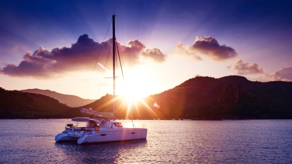 View of a Catamaran in the tropical sea at sunset