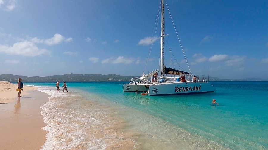 Tourists on a sailing boat and on the water of Buck Island