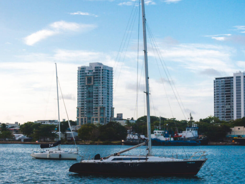 A boat sailing with skyline views at dusk