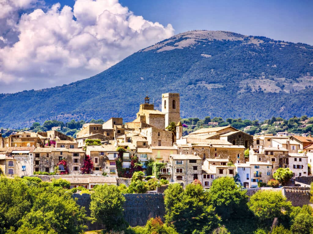 View of the medieval architecture in Saint-Paul-de-Vence with mountain views in the background