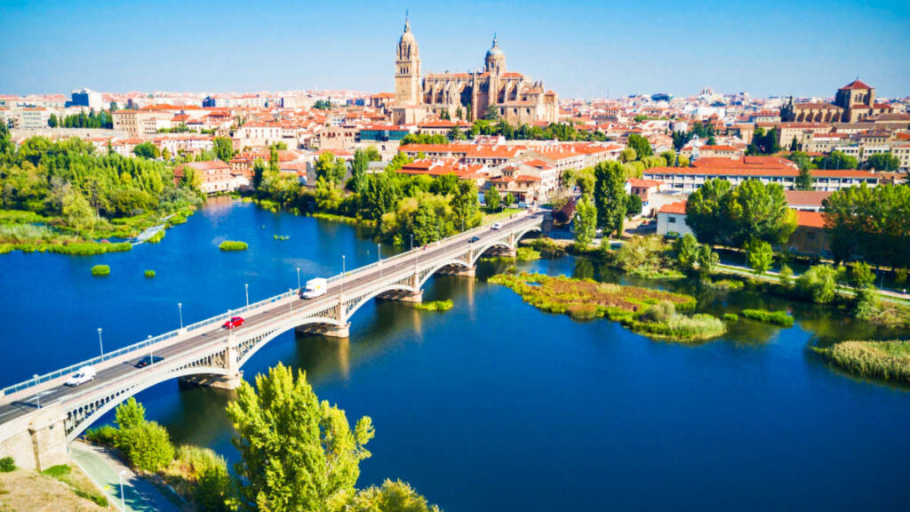 View of the Salamanca Cathedral from the distance with a clear blue sky in the background