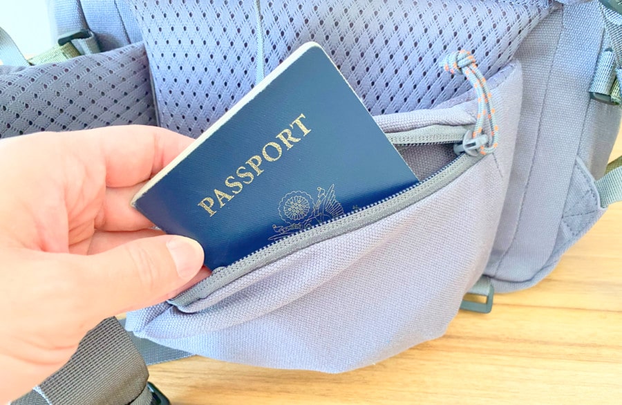 View of a hand inserting a passport into the Salkan hip pocket