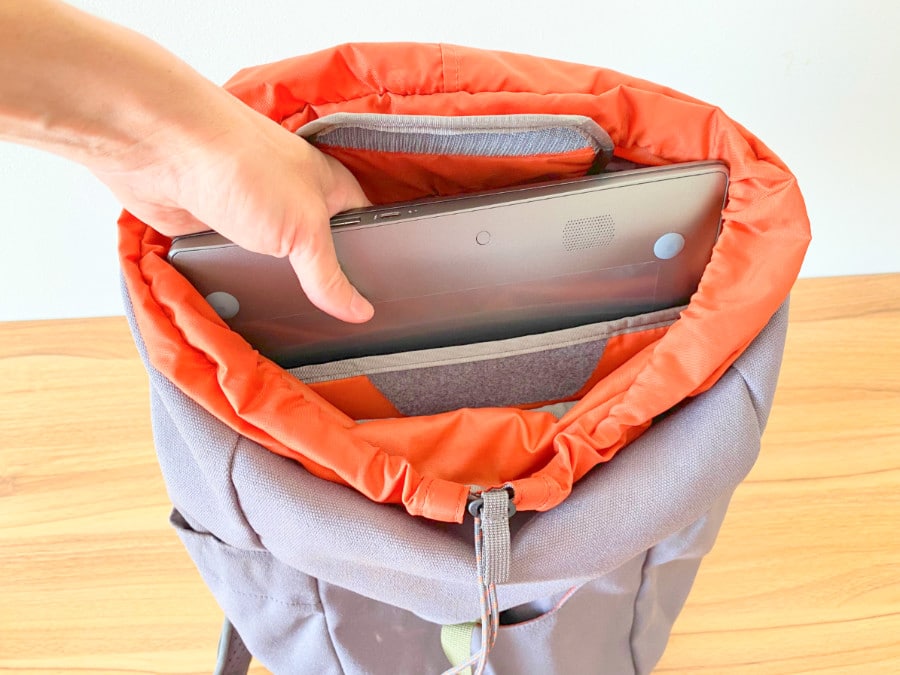 View of a hand inserting a laptop into the Salkan daypack