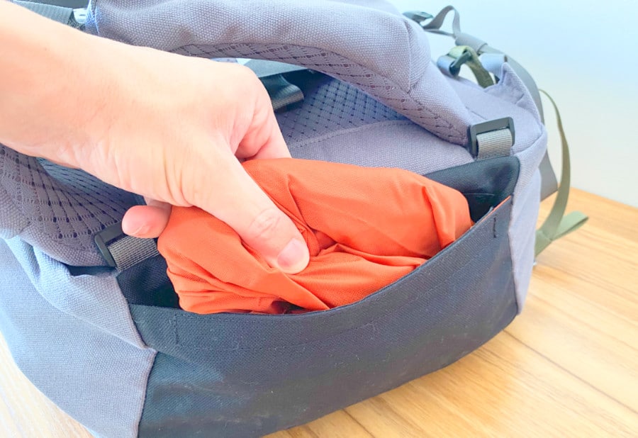 Handing inserting the Flight and Rain cover into the Salkan Mainpack bottom pocket