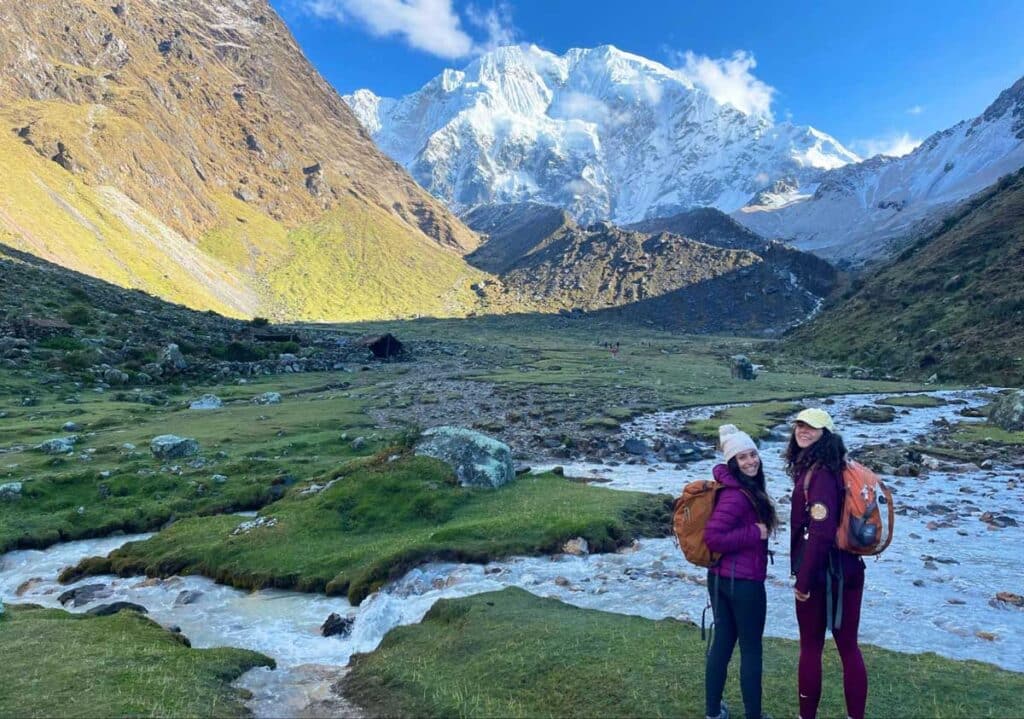 Travel Lemming writer McKenna with her friend smiling for a photo during a hike in Salkantay Trek
