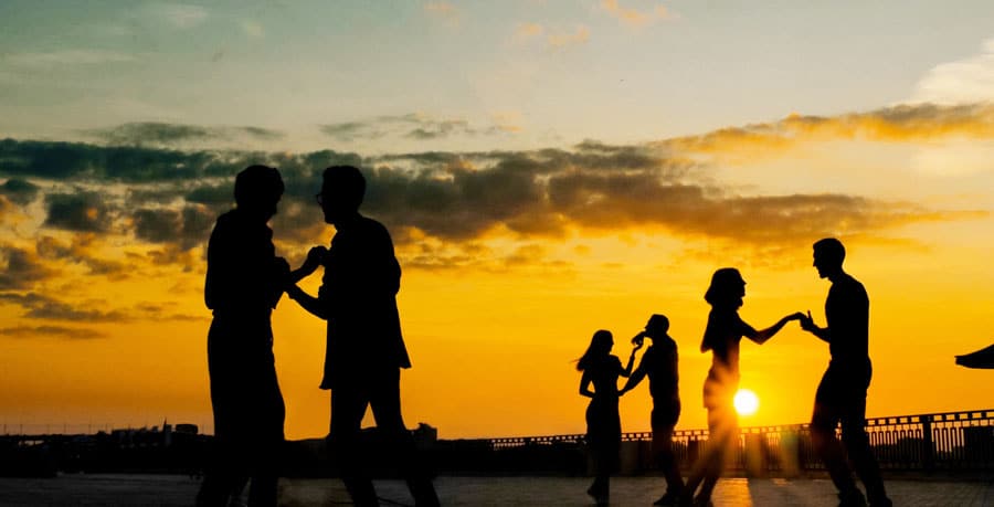 View of people's silhouette dancing during sunset