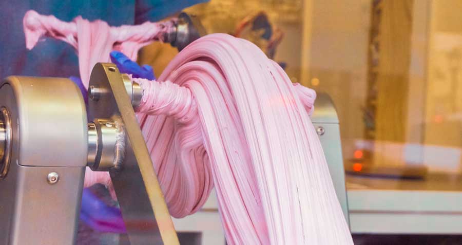 View while making a purple salt water taffy on a machine