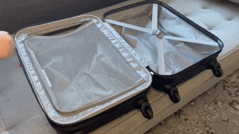 A hand demonstrating how smooth the inside zippers of Samsonite Omni