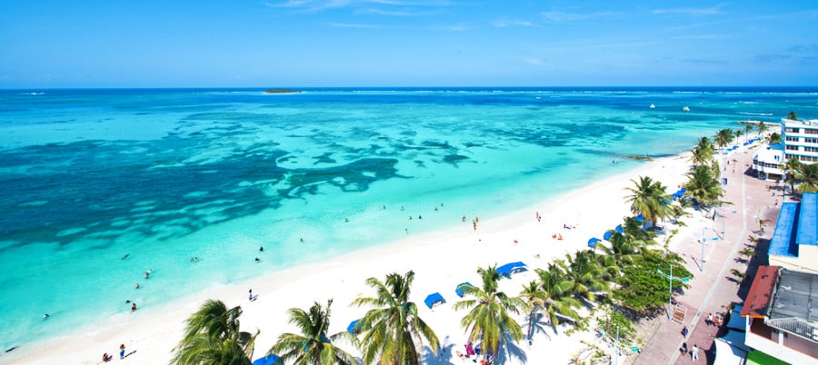 Aerial view of the white sand beach, lounge chairs and tropical trees in San Andres