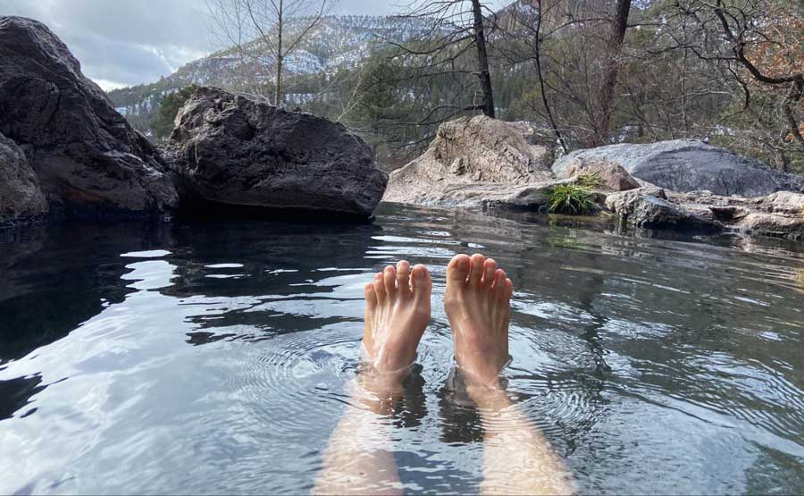 View of McKenna's feet while soaking in San Antonio Hot Springs