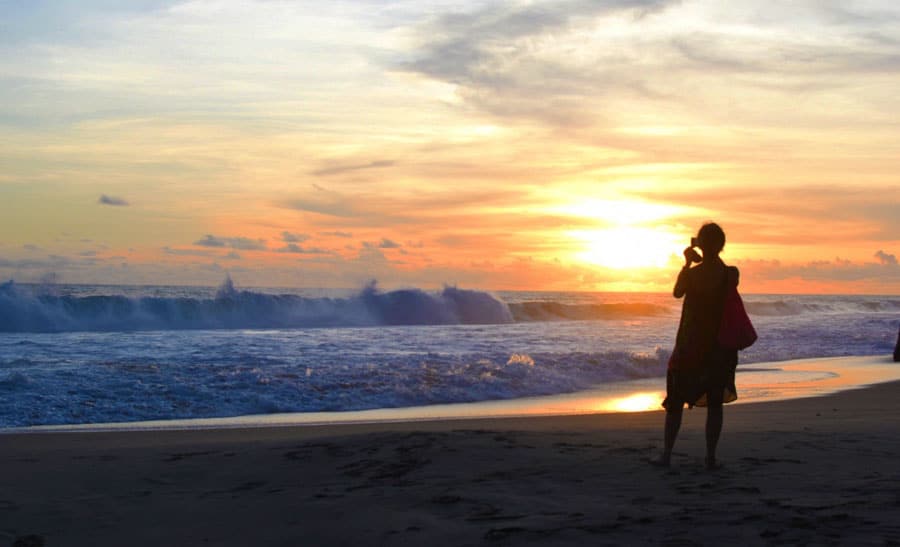 View of a person in San Diego beach admiring the sunset 