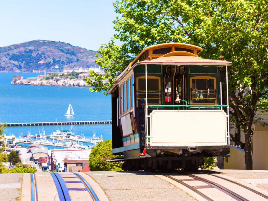 A tram on the track with scenic San Francisco view in the background