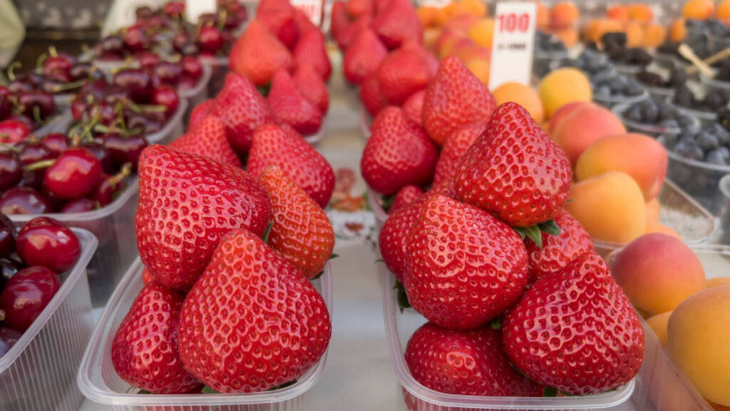 Close up view of fresh strawberries available in San Marcos Farmers Market