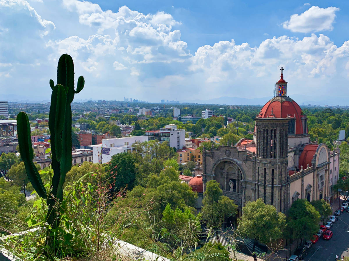 Aerial view of the cityscape and a red dome church in San Miguel Chapultepec