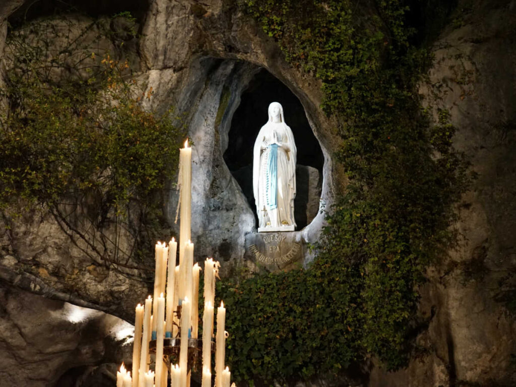 View of the candles in front of the statue at  the Sanctuary of Our Lady of Lourdes