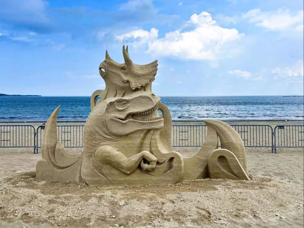 View of the sand sculptures of the dinosaurs on the Revere Beach