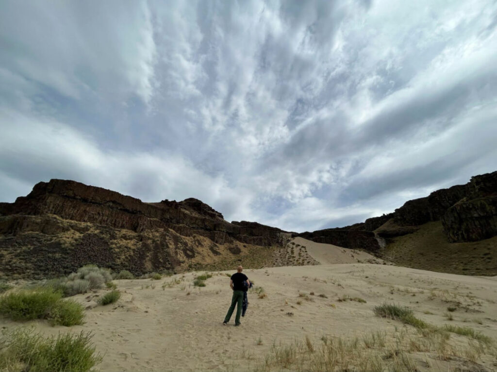A man standing at the Sand dunes at Babcock Bench