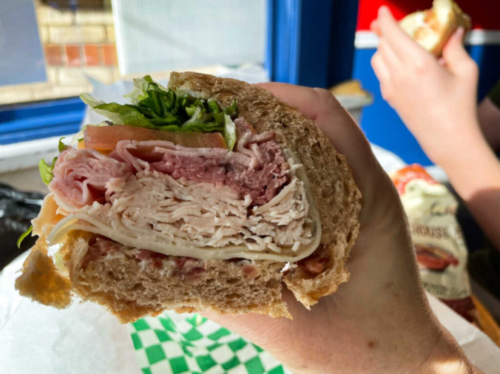 A hand holding a sandwich