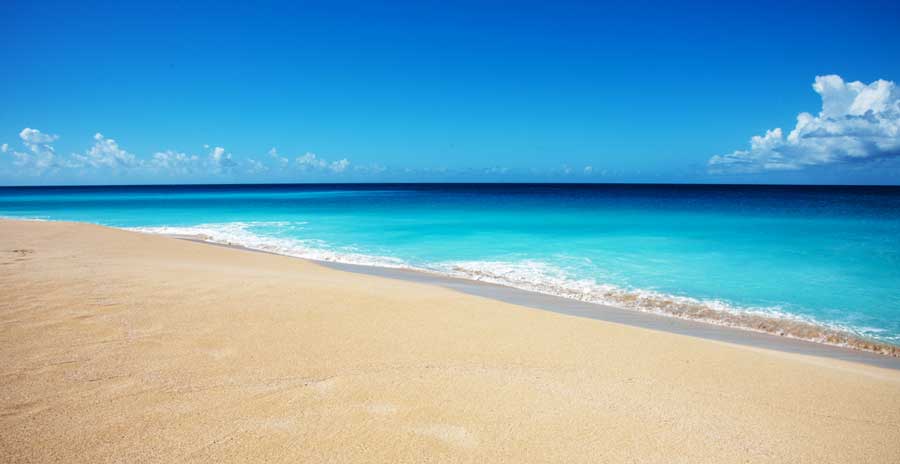 View of the blue water and sand in Sand Point Beach