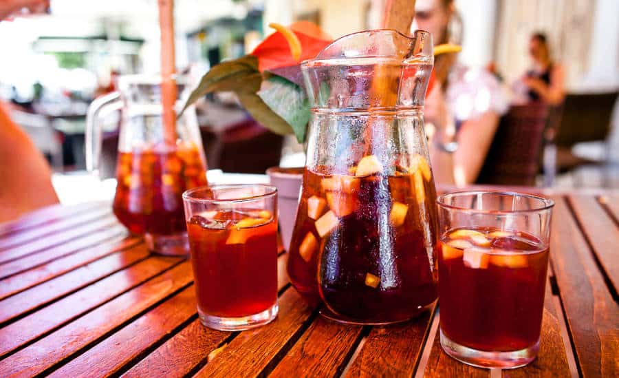 View inside the shop with a table of pitchers and glasses of sangria with fruits sliced into cubes