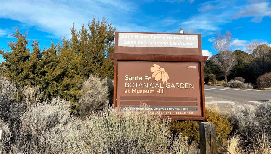 View of the Santa Fe Botanical Garden signage under the clear blue sky
