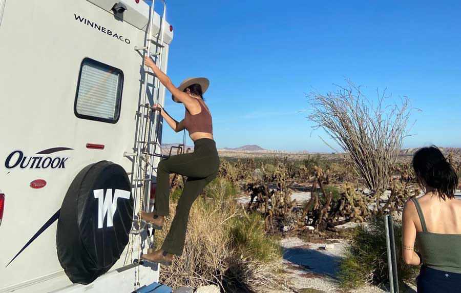 The author climbing on the RV in Santa Fe Skies RV Park