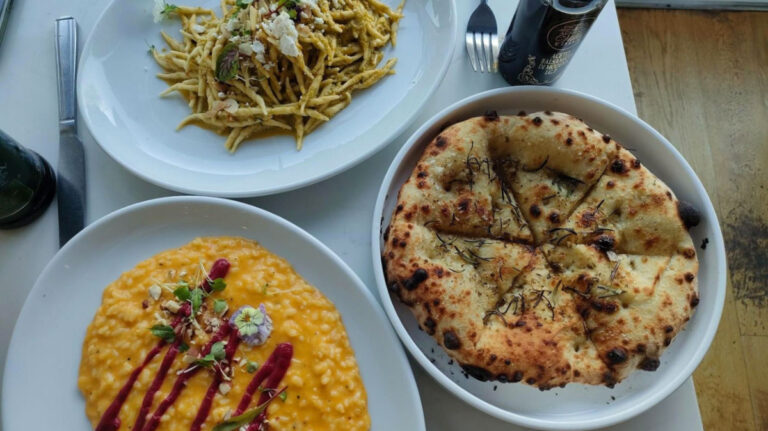 Plates of Santa Lucia’s finest focaccia, trofie pesto Siciliano, and risotto with roasted butternut squash