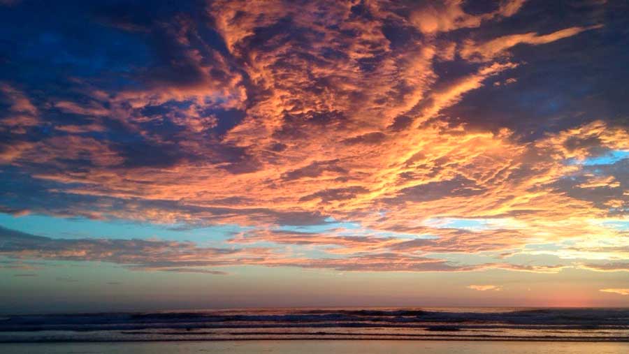 Colorful sky during a sunset over the beach of Santa Teresa
