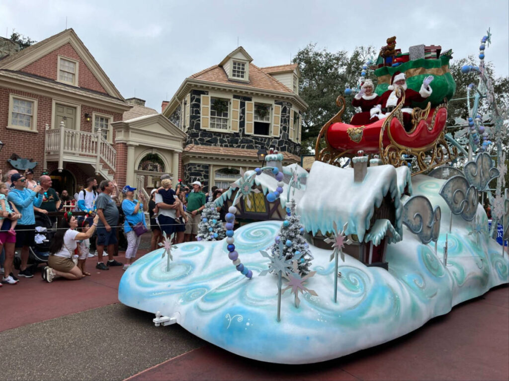 Santa and Mrs. Claus in a winter themed float at Magic Kingdom