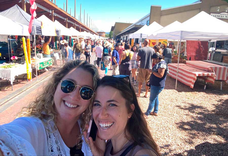 The author with her friend smiling for a selfie in Sante Fe Market