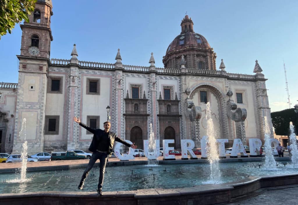 The author, Nate Hake posing for a photo with the water fountain in Santiago de Queretaro