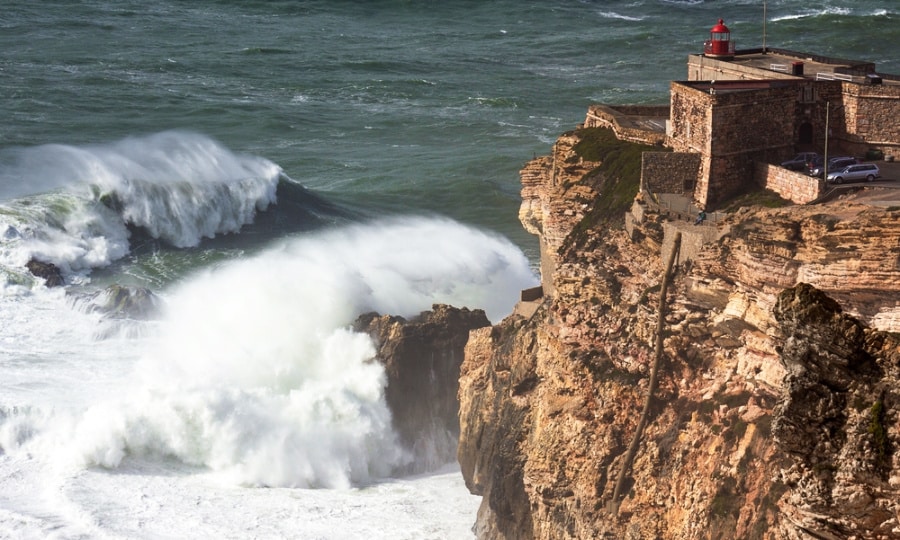 Giant ocean waves crash on the rocks of São Miguel Arcanjo Fort