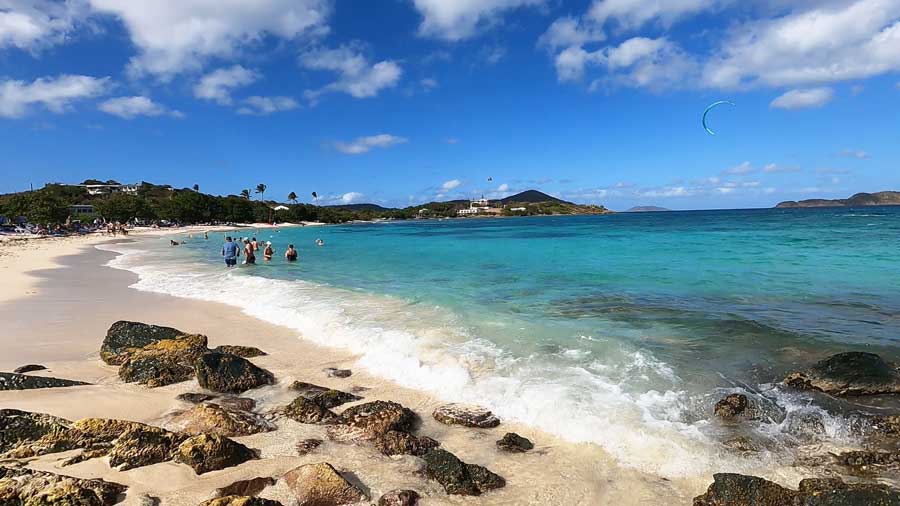 View of people and a rocky shoreline in Sapphire Beach