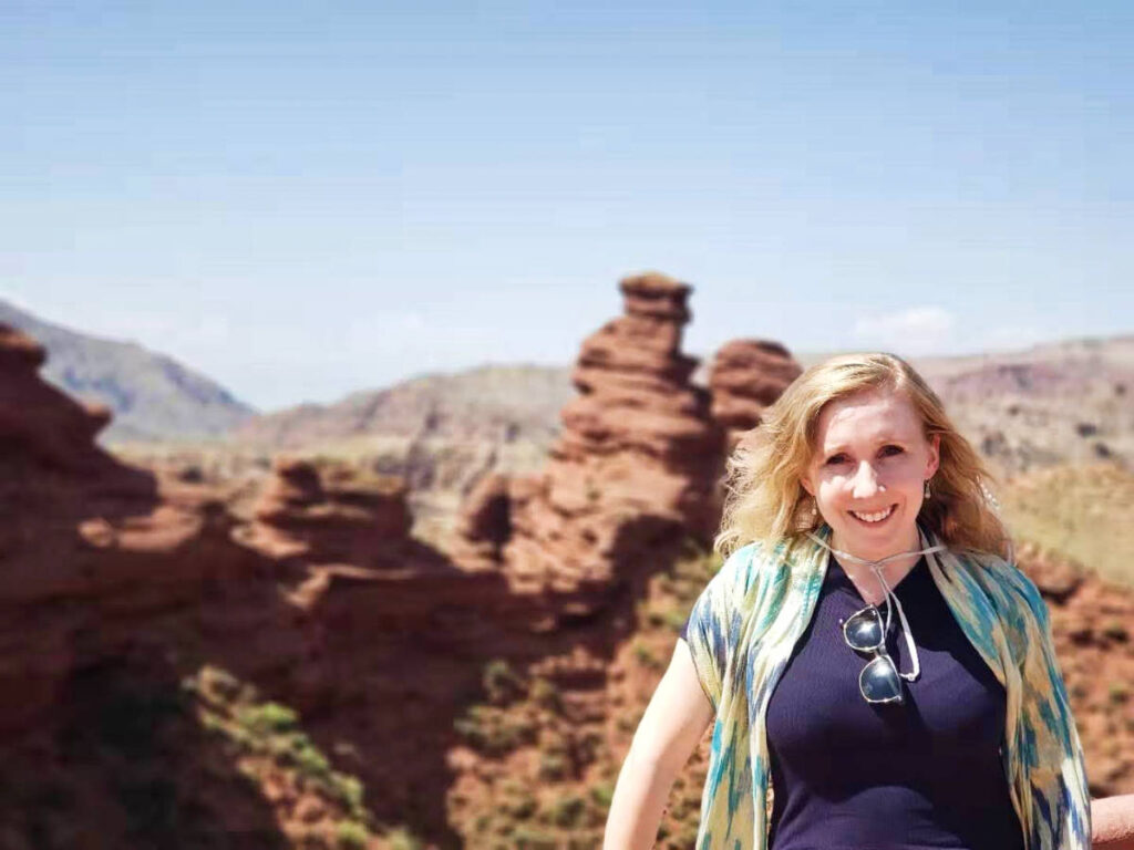 The author Sarah Heath smiling for a photo at the viewpoint of Pingshan Lake Grand Canyon