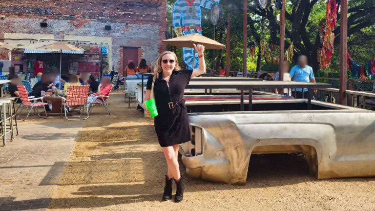 The author Sarah Heath, posing for a photo at the outdoor patio of Second Rodeo Brewing