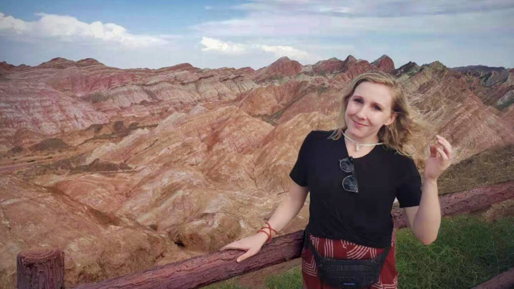 The author Sarah Heath, posing for a photo at the viewpoint of Zhangye National Geopark