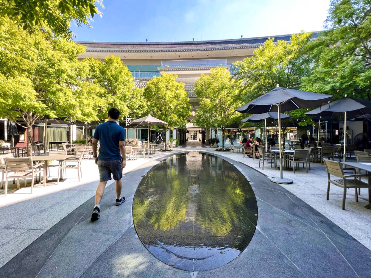 The author Sarah Heath's husband, wandering at the patio with tables and chairs around of Hotel Crescent Court in Uptown Dallas