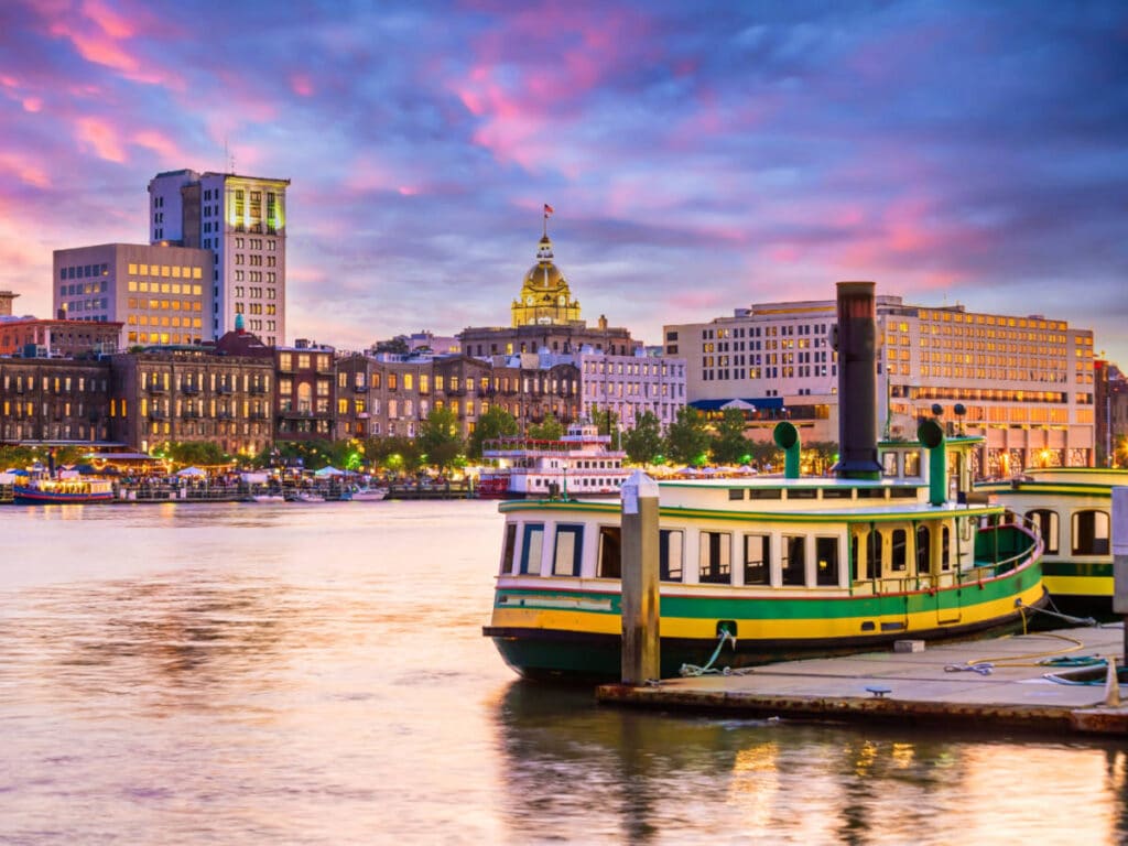 View of the waterfront Savannah and a docked boat at sunset