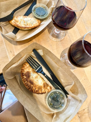 View of the empanadas and glasses of Malbec wine at Lazo Empanadas