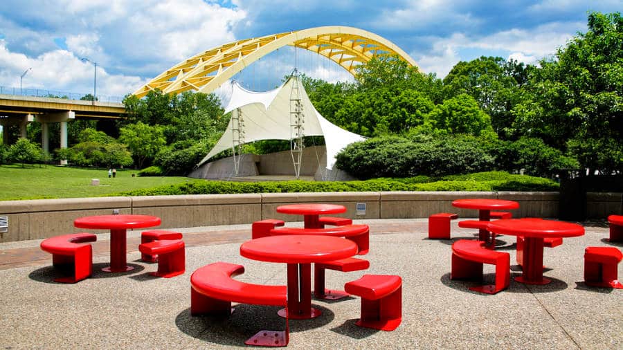 View of the red tables and chairs at Sawyer Point Park and Yeatman's Cove