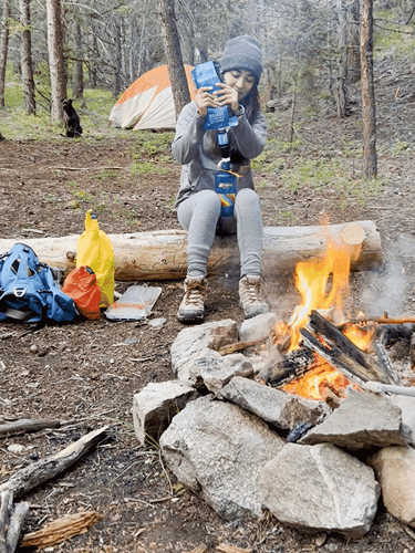 The author, Abigail Bliss using the Sawyer Squeeze water filter