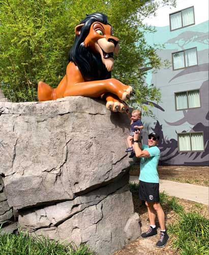 The author's husband holding their son while recreating one of the scene from the Lion King movie