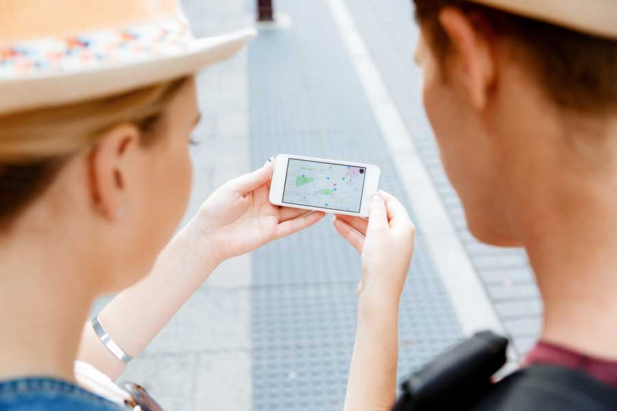 View of two people looking at the navigation app on the phone