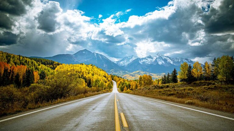 View of the fall foliage around the scenic byway with mountain views in the distance