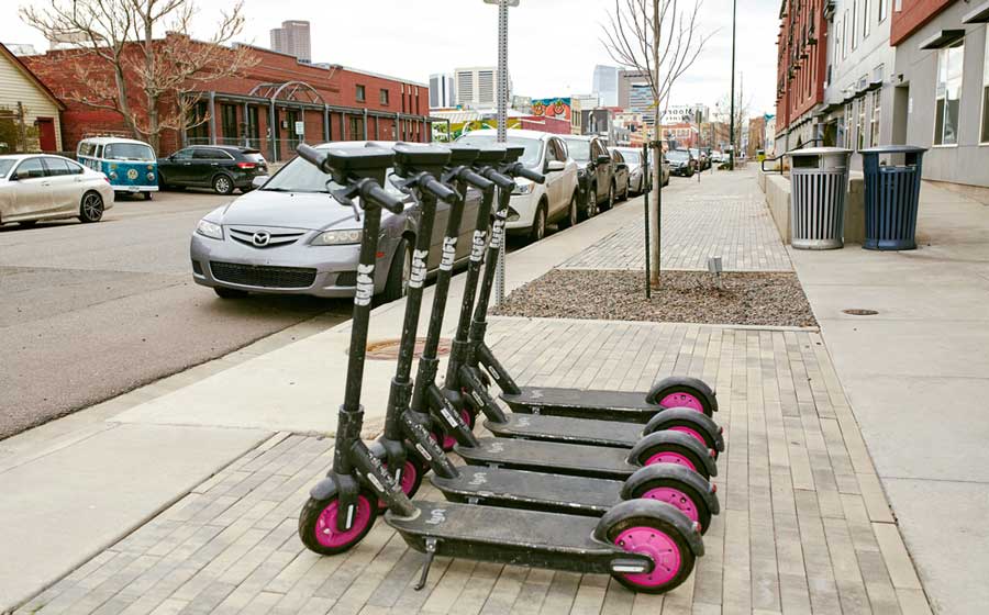 View of rental scooters on the side of the road in Denver