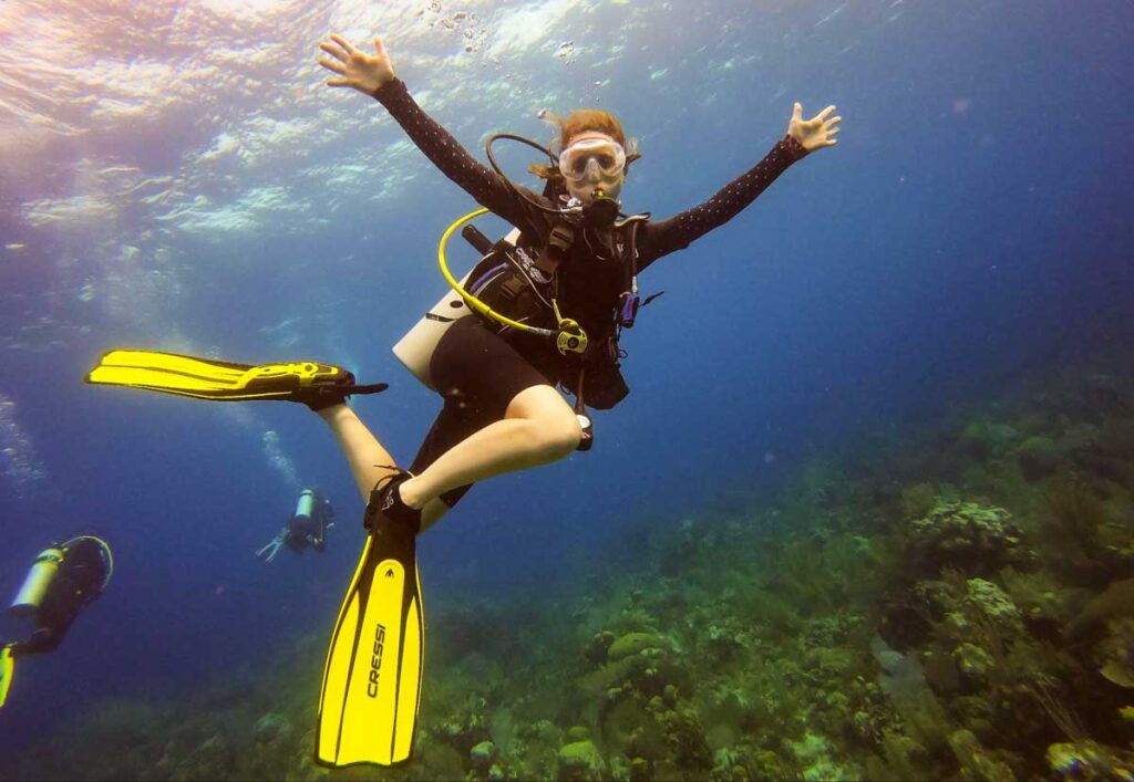 Travel Lemming writer Katie posing for a photo while scuba diving
