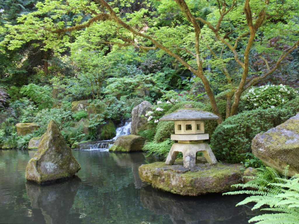 View of the greenery around the lake at the tranquil garden of Portland Japanese Garden