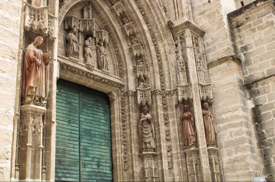 View of the sculptures on the intricate arch entrance of Seville Cathedral